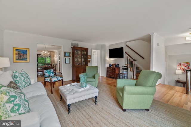 16 Lacosta Ct, Towson, MD 21204 - living area featuring a chandelier, stairway, light wood-type flooring, and ornamental molding