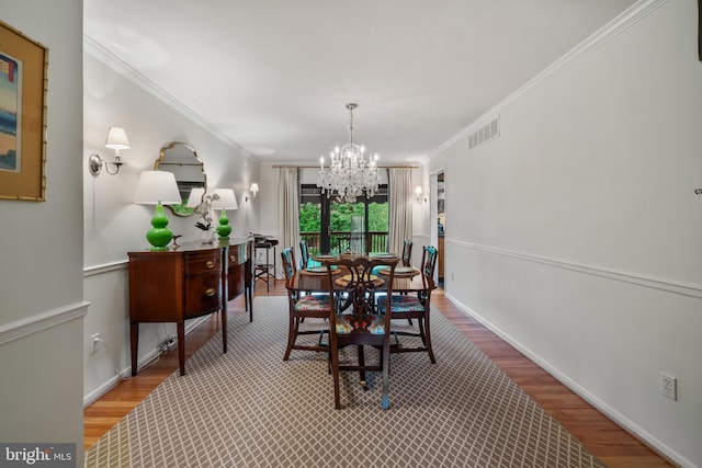 16 Lacosta Ct, Towson, MD 21204 - dining area featuring a chandelier, wood finished floors, crown molding, and baseboards