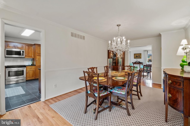 16 Lacosta Ct, Towson, MD 21204 - dining space with a chandelier, light wood-type flooring, and crown molding