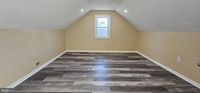 additional living space featuring wood finished floors, vaulted ceiling, baseboards, and recessed lighting