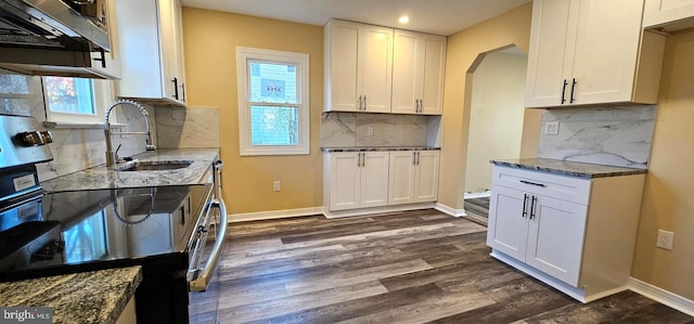 kitchen featuring dark wood-style floors, tasteful backsplash, white cabinets, light stone counters, and recessed lighting