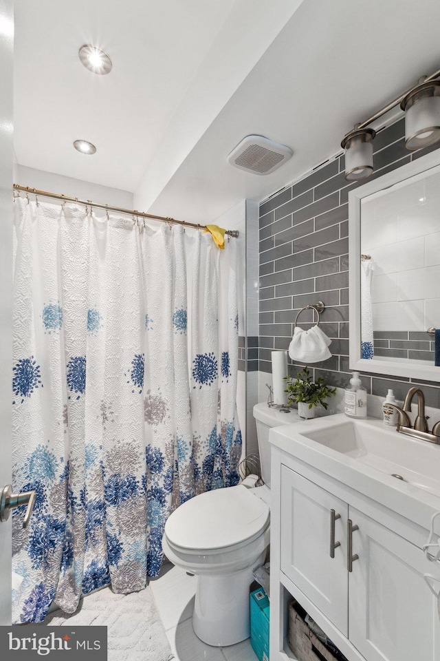 12906 7th St, Bowie, MD 20720 - full bathroom with toilet, vanity, tile walls, backsplash, and a shower with shower curtain