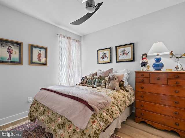 bedroom featuring light wood-type flooring, a ceiling fan, and baseboards