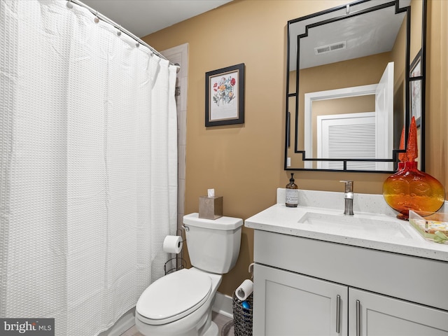 full bathroom with toilet and vanity