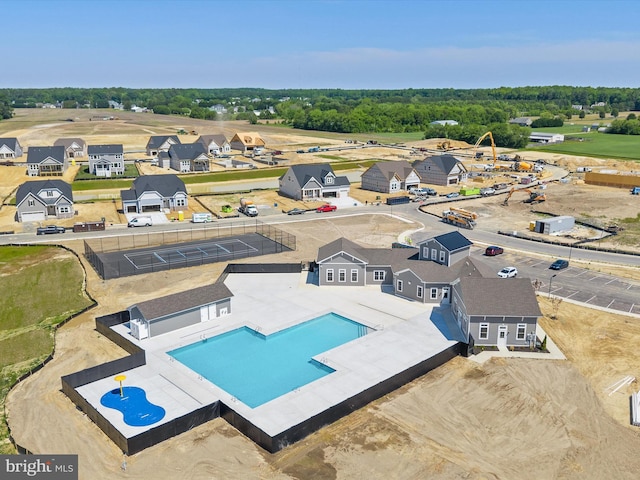 aerial perspective of suburban area featuring a pool