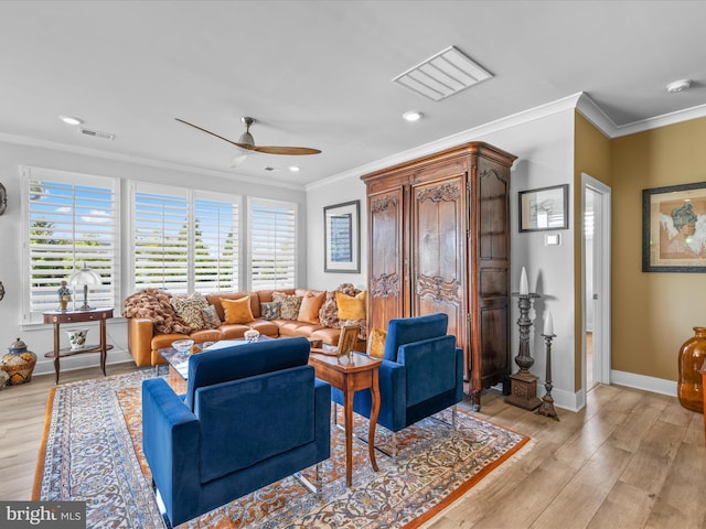 living room featuring ornamental molding, a ceiling fan, light wood-style flooring, recessed lighting, and baseboards