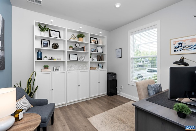 office space with light wood-style flooring, recessed lighting, and baseboards