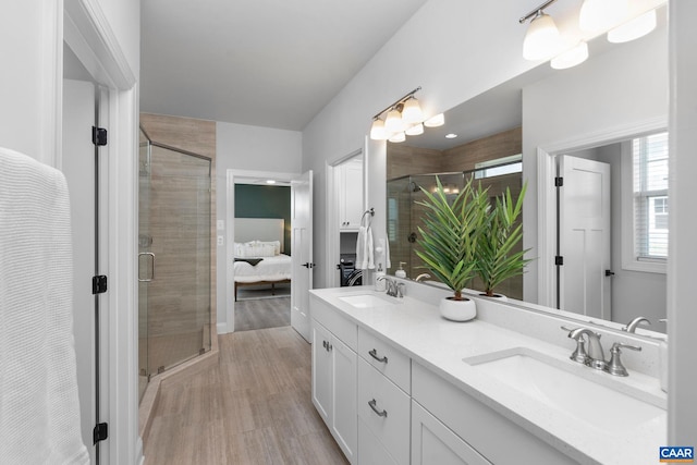 full bathroom featuring connected bathroom, a stall shower, and double vanity