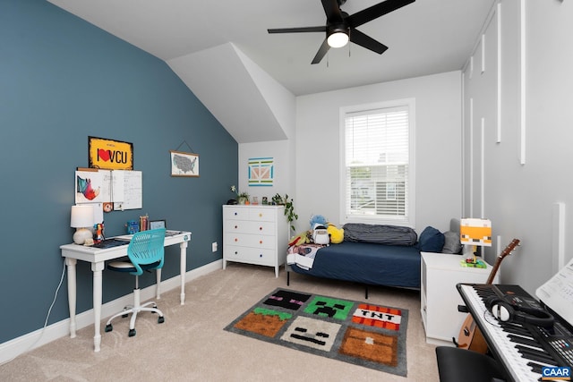 carpeted bedroom featuring a desk, baseboards, lofted ceiling, and ceiling fan