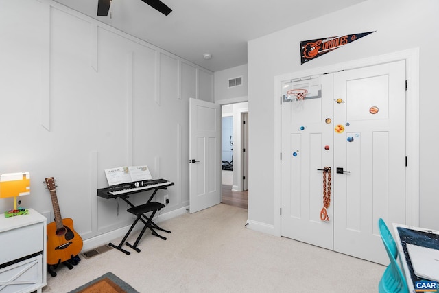 playroom featuring carpet, a ceiling fan, and baseboards