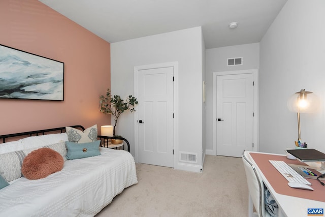 bedroom featuring light carpet, baseboards, and a desk