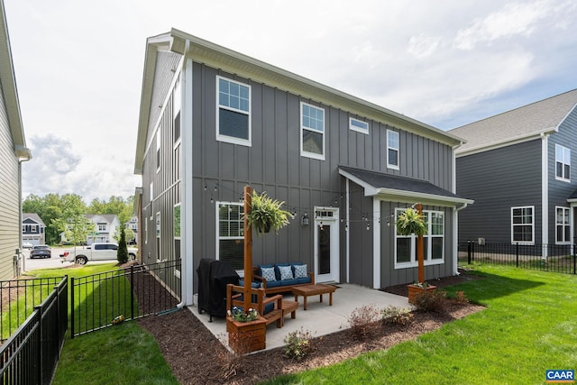 back of property featuring board and batten siding, outdoor lounge area, and a patio