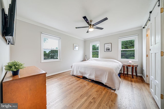 2015 Rollins Dr, Alexandria, VA 22307 - bedroom with light wood-style floors, baseboards, ornamental molding, a barn door, and a ceiling fan