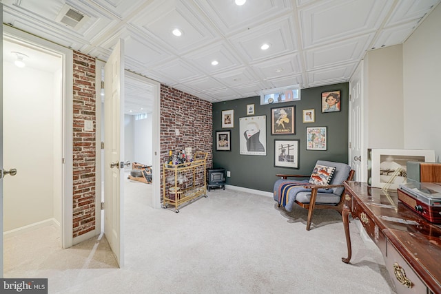 2015 Rollins Dr, Alexandria, VA 22307 - sitting room featuring carpet flooring, recessed lighting, a wood stove, baseboards, and brick wall