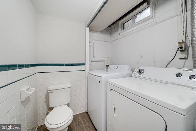 2015 Rollins Dr, Alexandria, VA 22307 - laundry area featuring washer and dryer, dark wood-type flooring, tile walls, and wainscoting