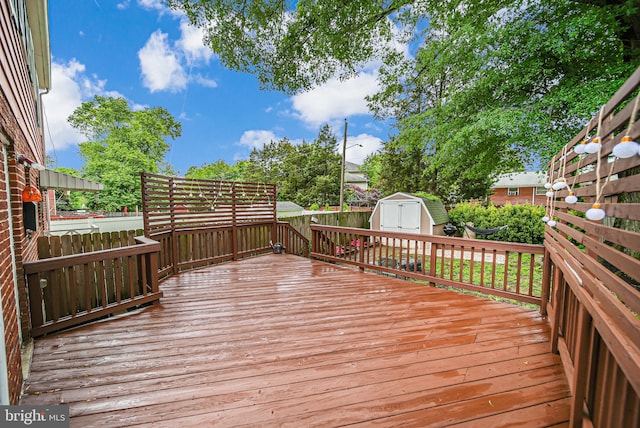 2015 Rollins Dr, Alexandria, VA 22307 - wooden deck featuring a storage shed, a fenced backyard, and an outdoor structure