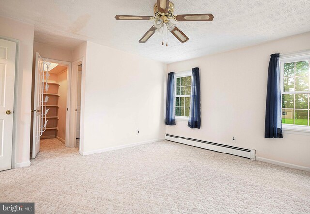 3019 Level Rd, Churchville, MD 21028 - unfurnished bedroom featuring a baseboard heating unit, carpet flooring, multiple windows, and a textured ceiling