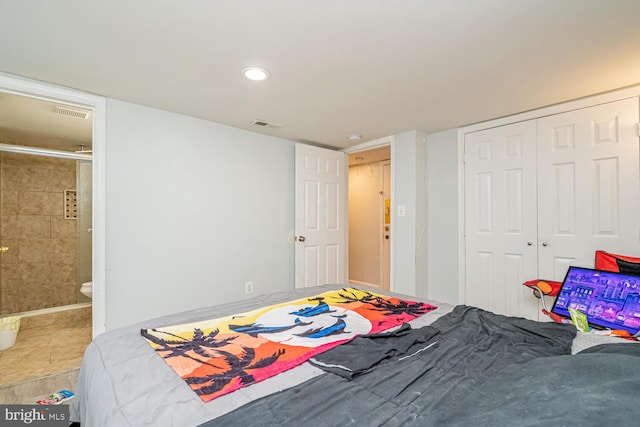 bedroom with a closet, ensuite bath, and recessed lighting