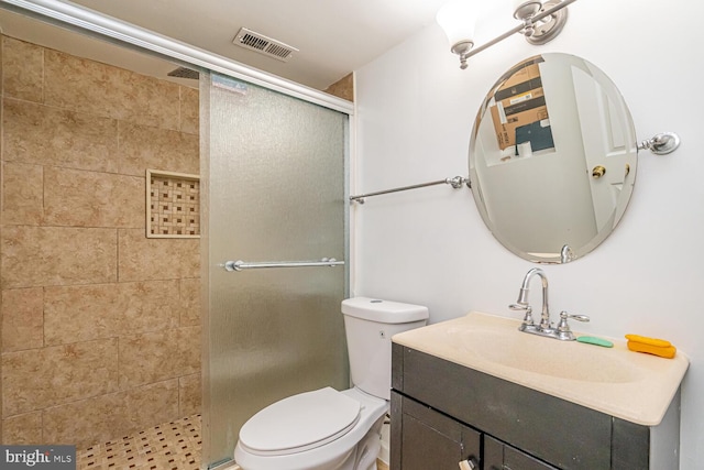 full bathroom with a stall shower, toilet, and vanity