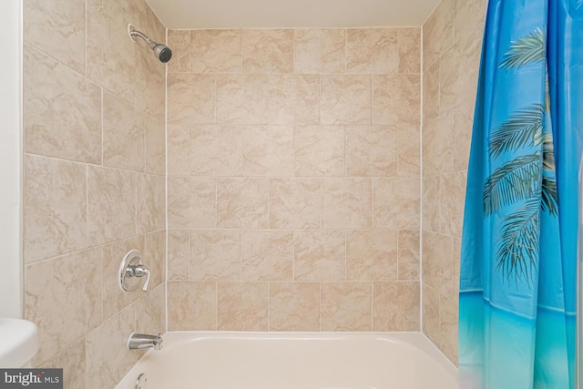 bathroom featuring shower / tub combo with curtain and toilet