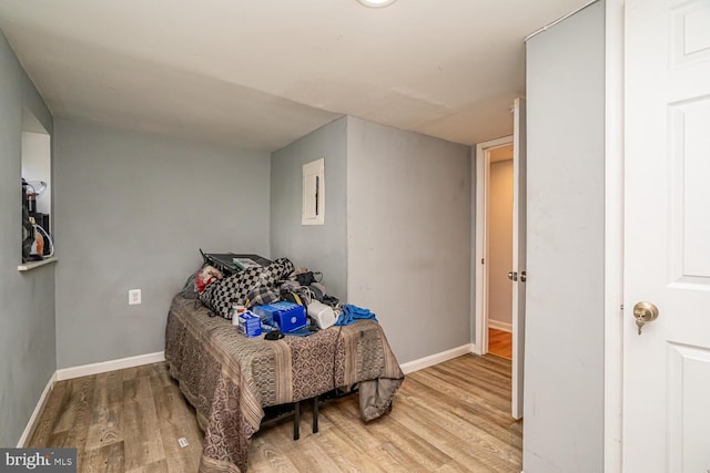 bedroom with wood finished floors and baseboards