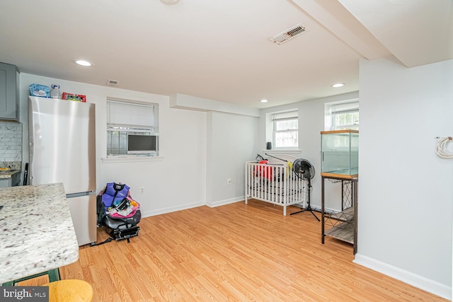 playroom with light wood-type flooring, baseboards, and recessed lighting