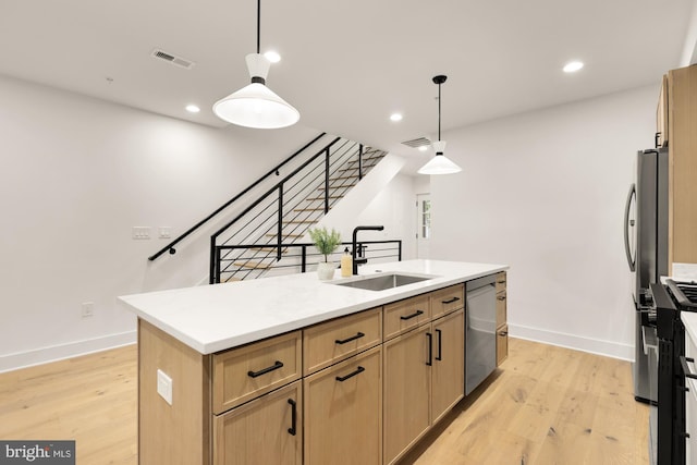 kitchen with a sink, stainless steel dishwasher, a center island with sink, baseboards, and recessed lighting