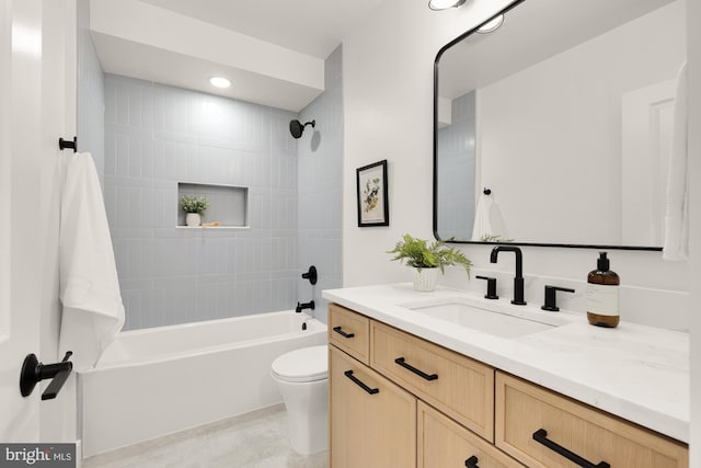 bathroom featuring toilet, bathtub / shower combination, vanity, and recessed lighting