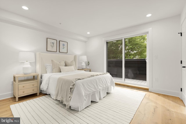bedroom with access to exterior, recessed lighting, wood finished floors, and baseboards