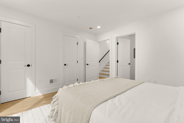 bedroom featuring light wood-style flooring, recessed lighting, and baseboards