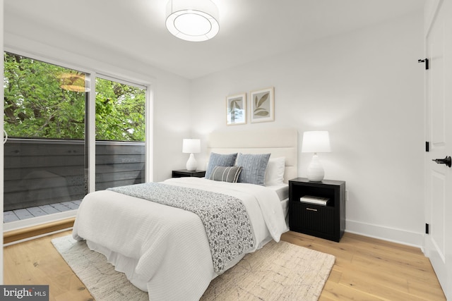 bedroom with wood finished floors and baseboards
