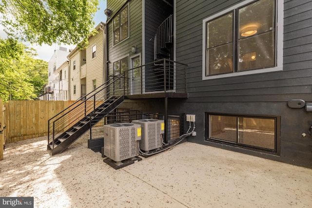 exterior space featuring central air condition unit and fence