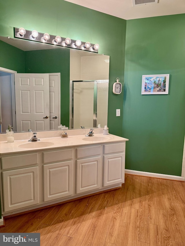 411 Hamlet Club Dr Unit 104, Edgewater, MD 21037 - full bathroom with wood finished floors, a stall shower, and double vanity