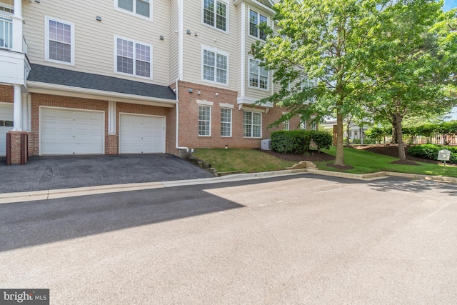 411 Hamlet Club Dr Unit 104, Edgewater, MD 21037 - view of front of house with brick siding, driveway, and a garage