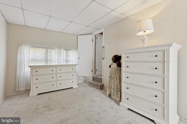 carpeted bedroom with a paneled ceiling