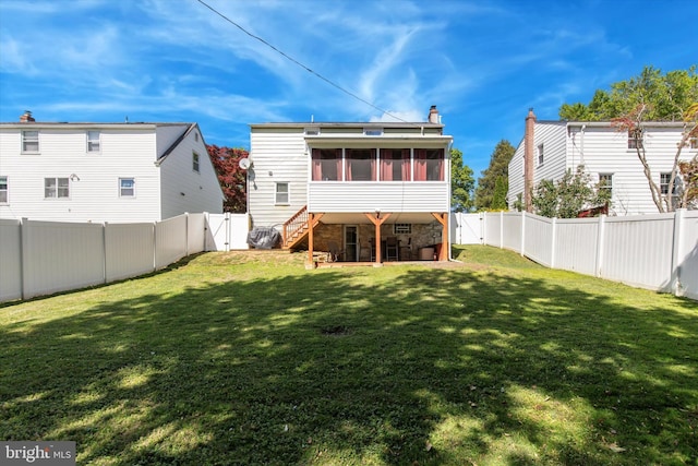 back of property with a sunroom, a gate, a chimney, and stone siding