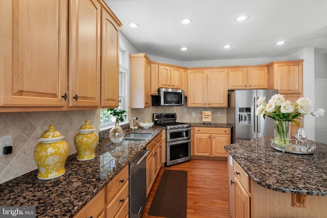47433 River Crest St, Sterling, VA 20165 - kitchen featuring appliances with stainless steel finishes, a sink, light brown cabinets, light wood-style flooring, and recessed lighting