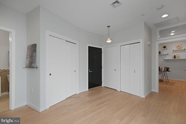 1414 Belmont St NW Unit 207, Washington, DC 20009 - unfurnished bedroom featuring multiple closets, light wood-style flooring, and baseboards