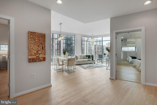 1414 Belmont St NW Unit 207, Washington, DC 20009 - living room featuring wood finished floors, baseboards, and recessed lighting