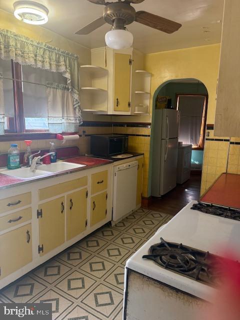 110 N Main St, Union Bridge, MD 21791 - kitchen featuring open shelves, a sink, white appliances, ceiling fan, and tile walls