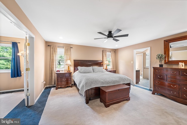 bedroom with light colored carpet, multiple windows, baseboards, and recessed lighting