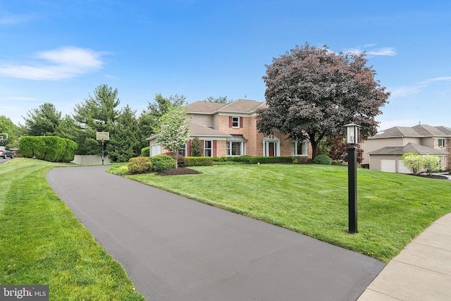 view of front of house with brick siding and a front yard