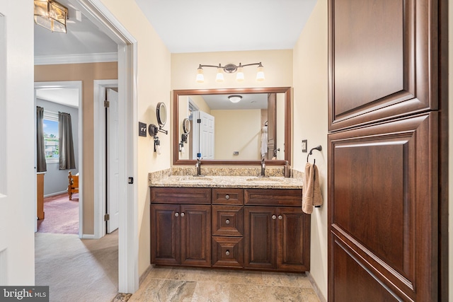 full bathroom featuring double vanity, baseboards, and ornamental molding