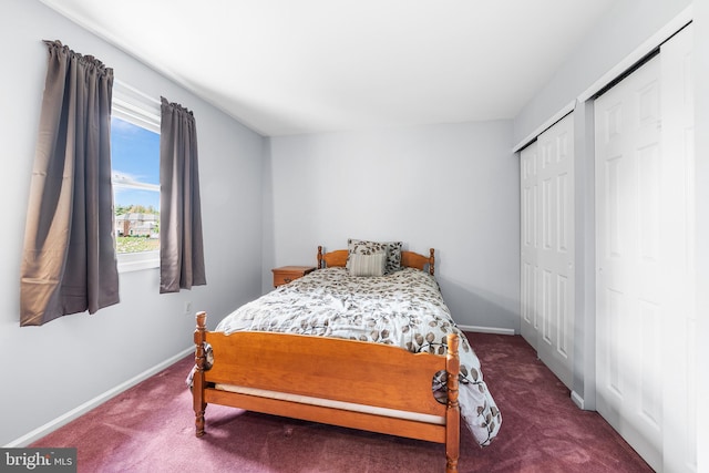 bedroom featuring carpet, baseboards, and two closets