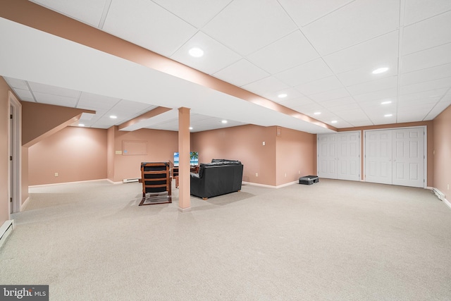 finished basement featuring a drop ceiling, baseboards, carpet, recessed lighting, and baseboard heating