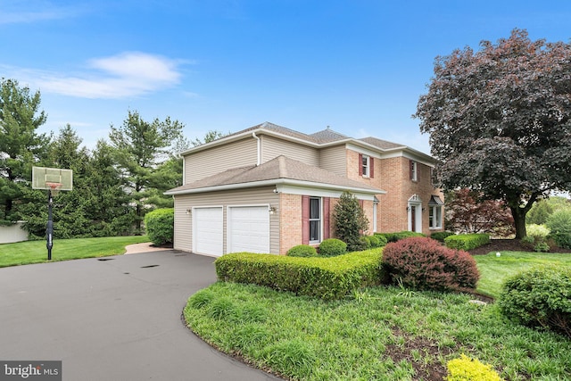 view of front of home with driveway, brick siding, and a shingled roof