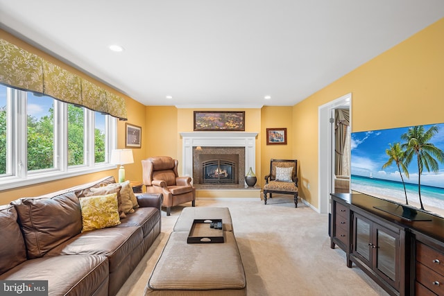 living area featuring light colored carpet, a lit fireplace, recessed lighting, and baseboards