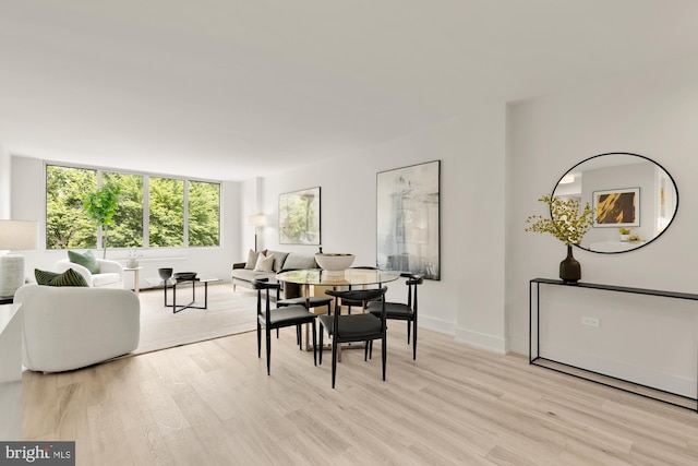 dining area with light wood-style flooring