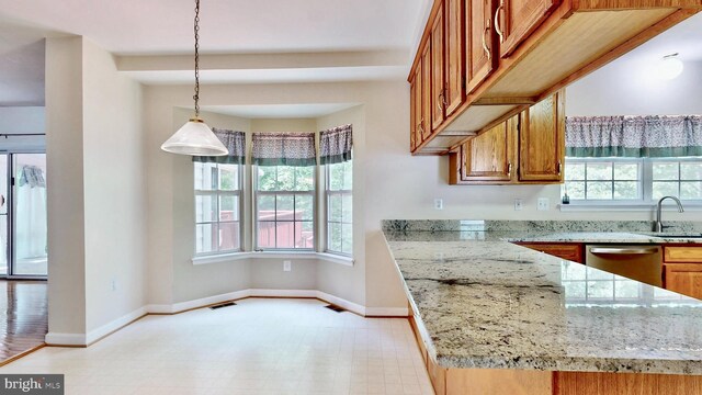 7265 Latham Ct, Hughesville, MD 20637 - kitchen with dishwasher, brown cabinets, baseboards, a sink, and hanging light fixtures