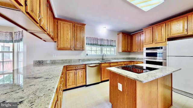 7265 Latham Ct, Hughesville, MD 20637 - kitchen with appliances with stainless steel finishes, a sink, light stone counters, and light flooring